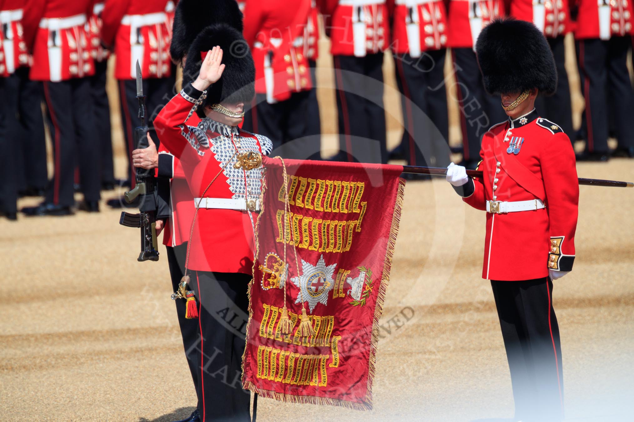 The Duty Drummer Sam Orchard salutes the Colour after removing the case from the Colour held by the Colour Sergeant Sam McAuley (31) during Trooping the Colour 2018, The Queen's Birthday Parade at Horse Guards Parade, Westminster, London, 9 June 2018, 10:33.