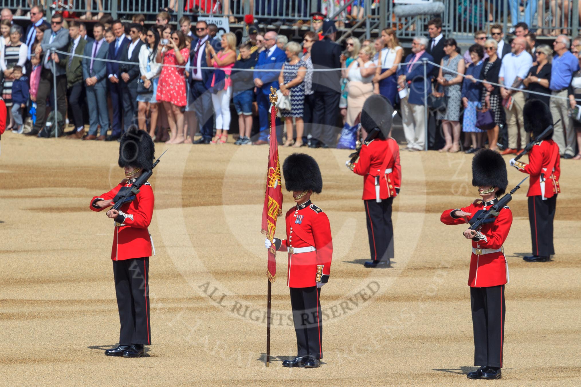 The Colour Sentry Guardsman Jonathon Hughes (26), Colour Sergeant Sam McAuley (31) holding the Colour, and the Colour Sentry Guardsman Sean Cunningham (21) during Trooping the Colour 2018, The Queen's Birthday Parade at Horse Guards Parade, Westminster, London, 9 June 2018, 10:38.