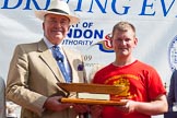 TOW River Thames Barge Driving Race 2013: The "Steven Bennet Memorial Trophy", presented to the apprentice on the winning barge, goes to M. O'Doherty of barge  "Blackwall", by the Port of London Authority. Here Admiral Alan West with M. O'Doherty and the trophy..
River Thames between Greenwich and Westminster,
London,

United Kingdom,
on 13 July 2013 at 16:28, image #579