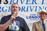 TOW River Thames Barge Driving Race 2013: A crew member of barge "Darren Lacey", by Princess Pocahontas, during a short speech. On the right Admiral Alan West..
River Thames between Greenwich and Westminster,
London,

United Kingdom,
on 13 July 2013 at 16:32, image #584