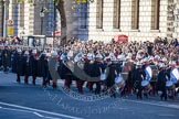 The Band of the Royal Marines, followef by a Royal Navy detachment, marching towards the Cenotaph.