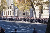 A detachment from from the Royal Navy, followed by the Royal Marines, marching along the northern side of Whitehall towards the Cenotaph.