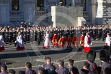 Following the Forces Chaplain and the Bishop of London, Cross Bearer, the 10 Children of the Chapel Royal, and the 6 Gentlemen-in-Ordinary ares leaving Whitehall towards the Foreign- and Commonwealth Office building.