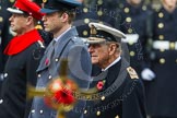 Remembrance Sunday at the Cenotaph in London 2014: HRH The Duke of Edinburgh, HRH The Duke of Cambridge, and HRH The Earl of Wessex, with the golden cross, out of focus, in front.
Press stand opposite the Foreign Office building, Whitehall, London SW1,
London,
Greater London,
United Kingdom,
on 09 November 2014 at 10:59, image #149