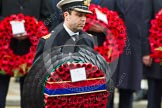 Remembrance Sunday at the Cenotaph in London 2014: Commander Andrew Canale, Royal Navy, Equerry to HM The Queen, handing over a wreath. The card says "In Memory of the Glorious Dead - Elizabeth R".
Press stand opposite the Foreign Office building, Whitehall, London SW1,
London,
Greater London,
United Kingdom,
on 09 November 2014 at 11:03, image #184