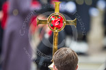 Remembrance Sunday at the Cenotaph 2015: Close-up of the Cross, with HM The Queen out of focus behind. Image #137, 08 November 2015 10:59 Whitehall, London, UK