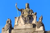 The statue of Queen Victoria as Britannia, seated between a lion and a unicorn, on top of the Foreign and Commonwealth Office overlooking the proceedings before the Remembrance Sunday Cenotaph Ceremony 2018 at Horse Guards Parade, Westminster, London, 11 November 2018, 08:46.