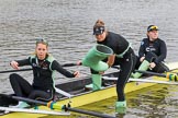 The Boat Race season 2017 - Women's Boat Race Fixture CUWBC vs Univerity of London: CUWBC's 3, Ashton Brown, 2 Kirsten van Fosen, and bow Claire Lamb getting rid of their Wellies.
River Thames between Putney Bridge and Mortlake,
London SW15,

United Kingdom,
on 19 February 2017 at 15:16, image #10