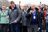 The Cancer Research UK Women's Boat Race 2018: Race umpire Sir Matthew Pinsent at the toss. On the left Cambridge stroke Olivia Coffey, and , with the microphone, for the BBC sports broadcaster David Mercer.
River Thames between Putney Bridge and Mortlake,
London SW15,

United Kingdom,
on 24 March 2018 at 14:40, image #34