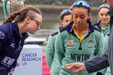 The Cancer Research UK Women's Boat Race 2018: OUWBC president Katherine Erickson and CUWBC president Daphne Martschenko at the toss, looking at the coin in Sir Matthew Pinsent's hand.
River Thames between Putney Bridge and Mortlake,
London SW15,

United Kingdom,
on 24 March 2018 at 14:40, image #41