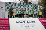 The Cancer Research UK Women's Boat Race 2018: The Women's Boat race trophy presentation - BBC Sport commentator Jason Mohammad, Myriam Goudet-Boukhatmi, Sophie Shapter, Olivia Coffey, Alice White, Boat Race Company director Fergus Murison, behind him Paula Wesselmann, then Thea Zabell, Kelsey Barolak, Imogen Grant, Tricia Smith, and CUWBC Head Coach Rob Baker.
River Thames between Putney Bridge and Mortlake,
London SW15,

United Kingdom,
on 24 March 2018 at 17:07, image #268