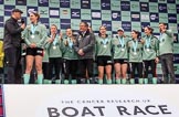 The Cancer Research UK Women's Boat Race 2018: The Women's Boat race trophy presentation - BBC Sport commentator Jason Mohammad, Myriam Goudet-Boukhatmi, Sophie Shapter, Olivia Coffey, Alice White, Boat Race Company director Fergus Murison, behind him Paula Wesselmann, then Thea Zabell, Kelsey Barolak, Imogen Grant, Tricia Smith, and CUWBC Head Coach Rob Baker.
River Thames between Putney Bridge and Mortlake,
London SW15,

United Kingdom,
on 24 March 2018 at 17:08, image #270