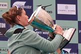 The Cancer Research UK Women's Boat Race 2018: Cambridge 7 seat Myriam Goudet-Boukhatmi drinking champagne out of the Women's Boat Race trophy.
River Thames between Putney Bridge and Mortlake,
London SW15,

United Kingdom,
on 24 March 2018 at 17:09, image #290