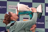 The Cancer Research UK Women's Boat Race 2018: Cambridge 7 seat Myriam Goudet-Boukhatmi drinking champagne out of the Women's Boat Race trophy.
River Thames between Putney Bridge and Mortlake,
London SW15,

United Kingdom,
on 24 March 2018 at 17:09, image #291