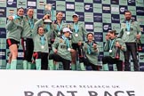 The Cancer Research UK Women's Boat Race 2018: The Cambridge women on the podium, with the Women's Boat Race trophy, their medals, lots of Castle Down Brut, and Cambridge head coach Rob Baker: Myriam Goudet-Boukhatmi, Olivia Coffey, Alice White, Paula Wesselmann, The Zabell, Sophie Shapter, Kelsey Barolak , Imogen Grant, and Tricia Smith.
River Thames between Putney Bridge and Mortlake,
London SW15,

United Kingdom,
on 24 March 2018 at 17:10, image #300