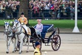 Trooping the Colour 2010: Her Majesty The Queen, sitting in her Ivory Mounted Phaeton,  inspecting the line of soldiers on the parade ground.

In the background spectators watching from St. James's Park, on the western end of the parade ground, and in the foreground one of the Drum Majors..
Horse Guards Parade, Westminster,
London SW1,
Greater London,
United Kingdom,
on 12 June 2010 at 11:06, image #88