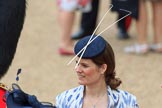 Female spectator wearing a fascinator with two long sticks before Trooping the Colour 2018, The Queen's Birthday Parade at Horse Guards Parade, Westminster, London, 9 June 2018, 09:14.