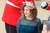 Curly haired woman wearing a fascinator before Trooping the Colour 2018, The Queen's Birthday Parade at Horse Guards Parade, Westminster, London, 9 June 2018, 09:15.